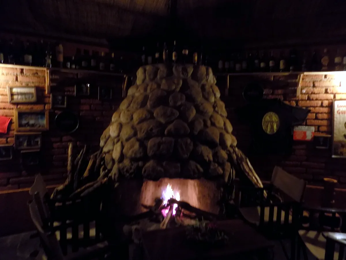 Log fire burning in the stone fireplace of the Irish Bar